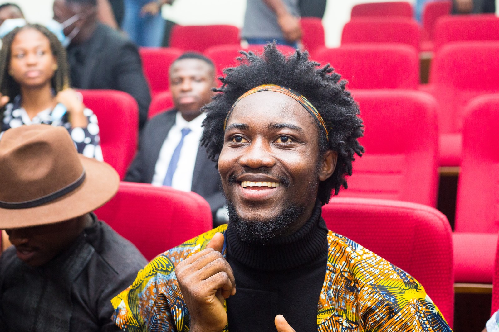 Radiant audience laughter in auditorium
