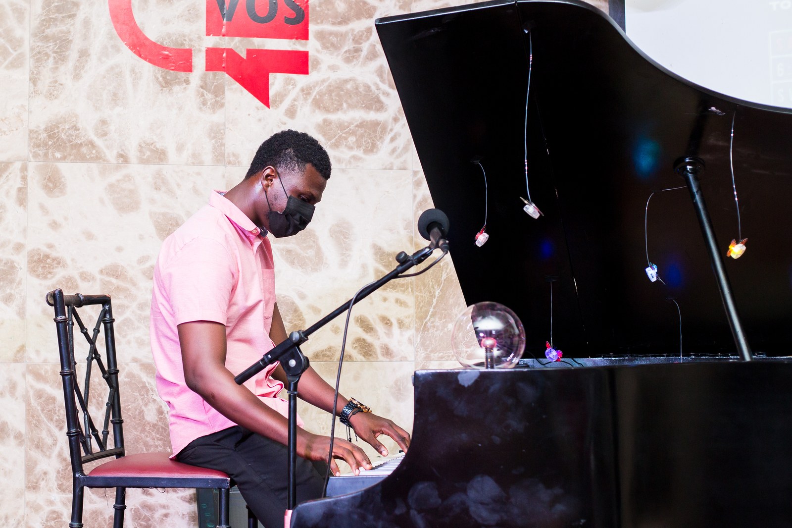 Live pianist at grand piano with Creative Convos backdrop