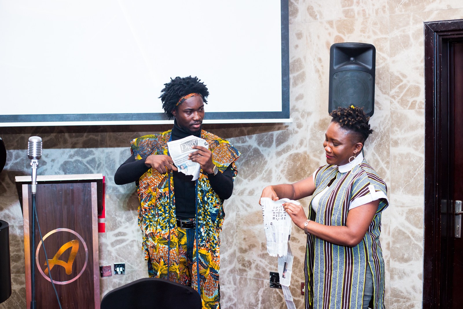 Performers tearing paper and reciting unscripted poetry